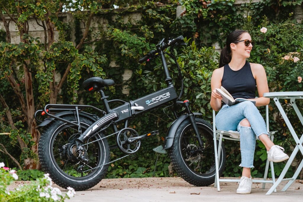 A Woman Sitting beside an Electric Bike